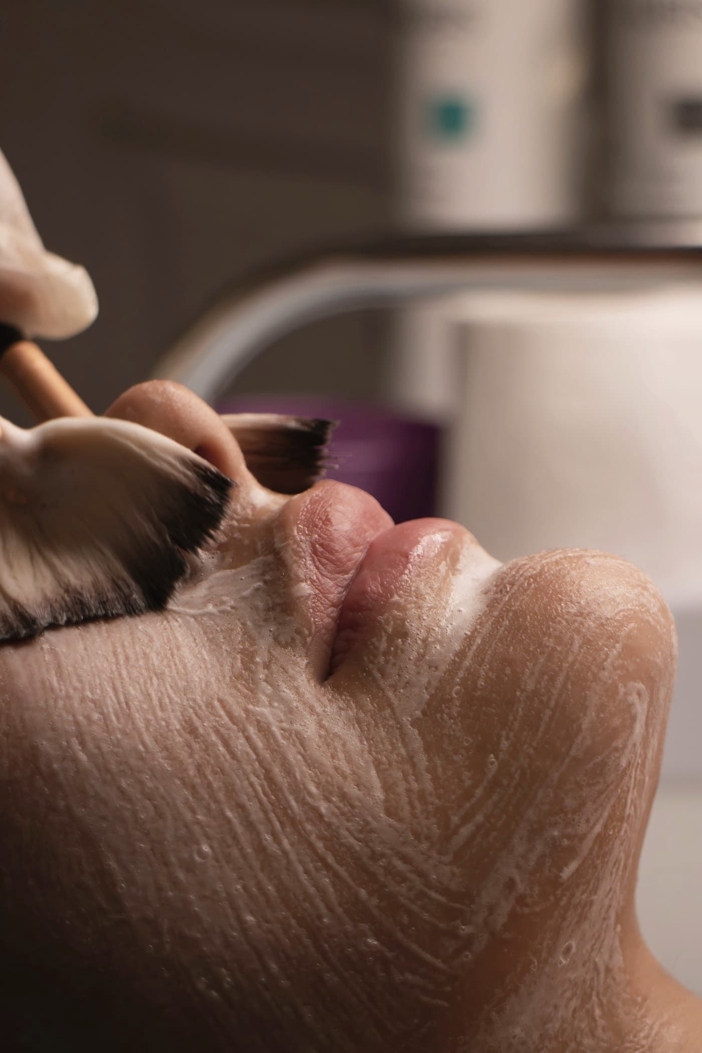 Treatment product applied with a brush during a facial